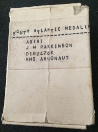 An Outstanding ROYAL NAVY South Atlantic (Falklands War)
Medal with Rosette.To: AB. J.W. PARKINSON. D182476K 
Crew of  ”Leander Class Destroyer” H.M.S. ARGONAUT. Badly Damaged when Hit by Two Unexploded Argentinian Bombs.