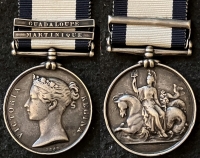 A Rare Officer’s NAVAL GENERAL SERVICE MEDAL (Two Clasps)
GUADALOUPE & MARTINIQUE  To: Lieut JOHN MACNEVIN R.N. Fought at New Orleans, U.S.A. during American War of 1812.
Full service record & biography.